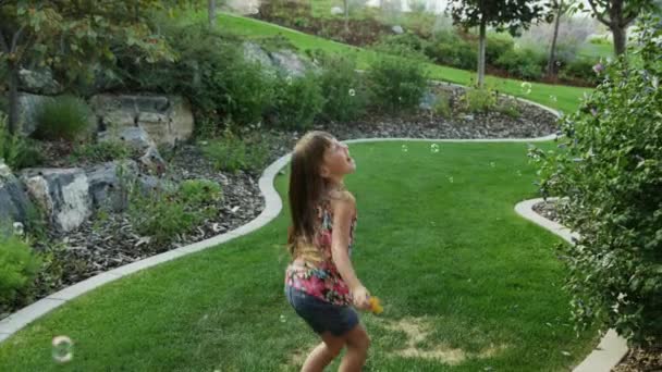 Girl playing with soap bubbles — Stock Video