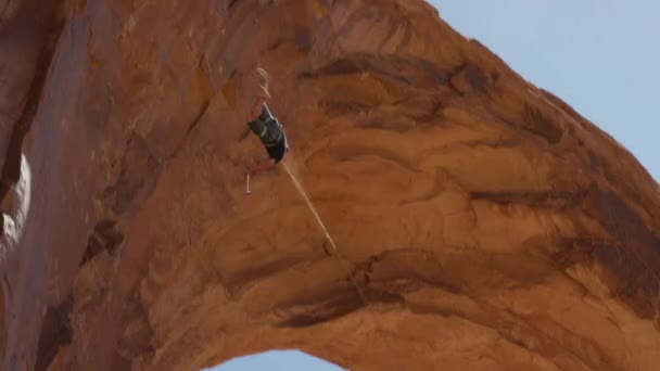 Человек, качающийся из арки — стоковое видео