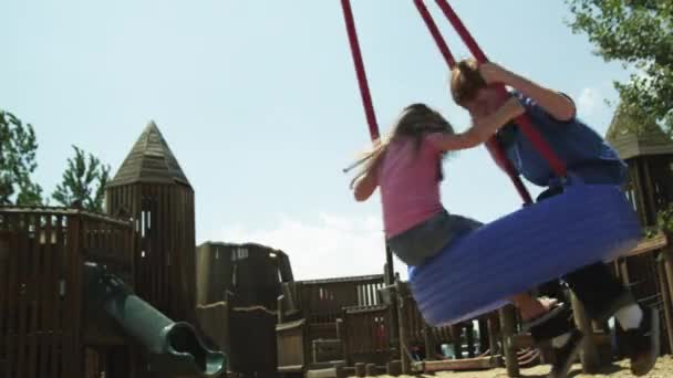 Menina e menino no pneu swing no parque , — Vídeo de Stock