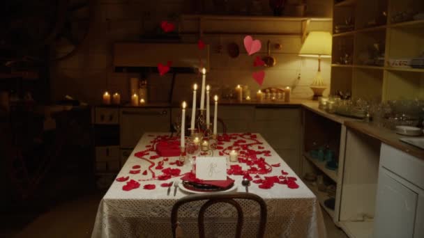 Table covered in candles and rose petals — Stock Video