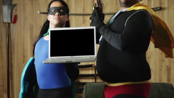 Men in superhero costumes holding laptop — Stock Video