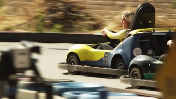 Woman and man riding go-carts — Stock Video