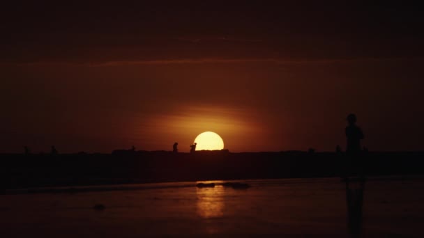 在日落时在海滩上行走的人 — 图库视频影像