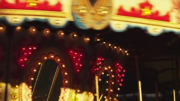 Illuminated carousel spinning at night — Stock Video