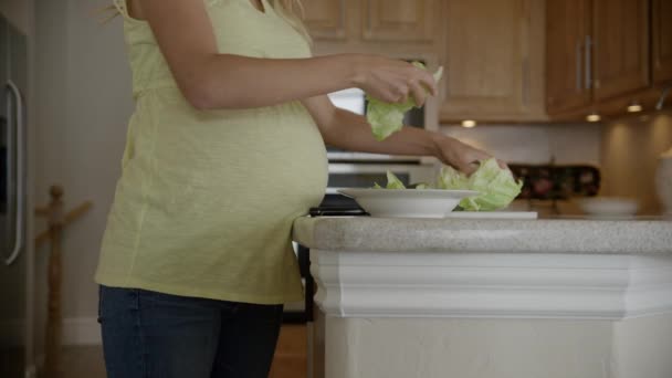 Pregnant woman preparing salad — Stock Video