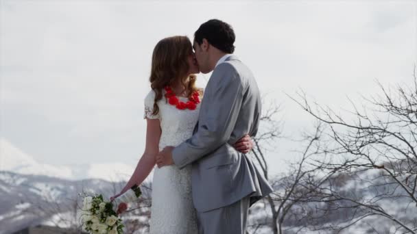 Bride and groom kissing outdoors — Stock Video