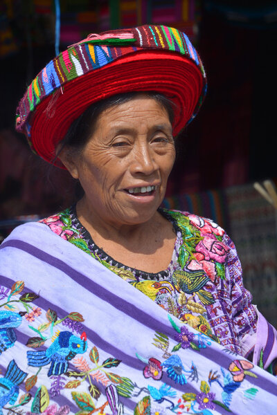 Tzutujil woman show to wearing a traditional toyocal hat