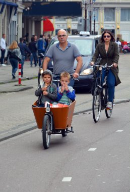  Amsterdam, Hollanda 10. 01 2015: Amsterdam 'da bisikletle gezen iki çocuklu baba