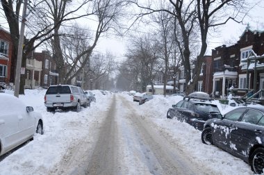MONTREAL-CANADA DEC. 27:Cars cover of snow on Merose Street. The snow storm slam Montreal with 45 cm of snow, Canada on December 27, 2012 after knocking out power to thousands of homes in the U.S..