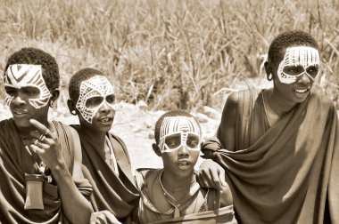 SERENGETI- TANZANIA - OCTOBER 20: Unidentified Young Masai men (Moran) wear black and markings for several months following their circumcision on October 20, 2011 Serengeti Tanzania.