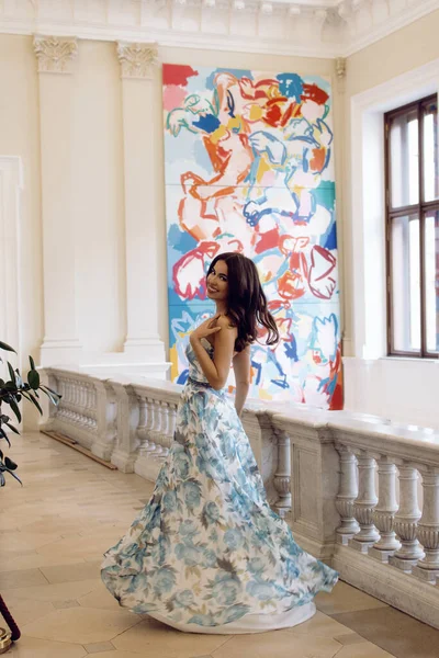 Gorgeous young lady in elegant clothes in a historic building