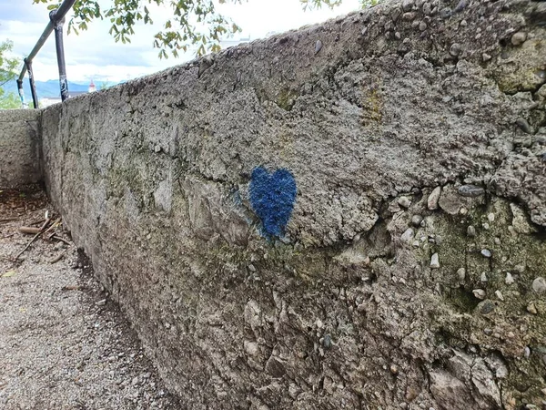 gray stone wall blue heart. drawing blue heart on a grey stone