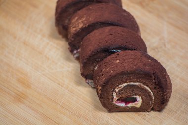 Lezzetli çikolata ahşap tahta arka plan üzerinde plaka rulo