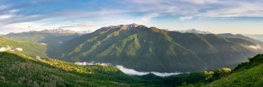 Mountain field during sunset with mountains in the background. Adygea, do-do-gush. Beautiful natural landscape. High quality photo