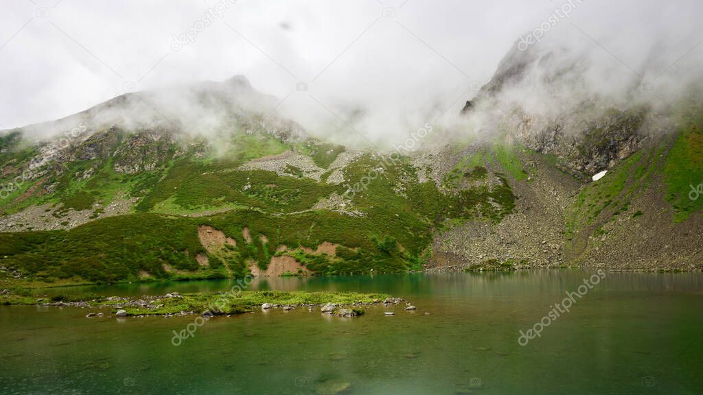 Alpine turquoise lake of Sofia, surrounded by rocks. Karachay-Cherkessia, Arkhyz. Russia. High quality photo
