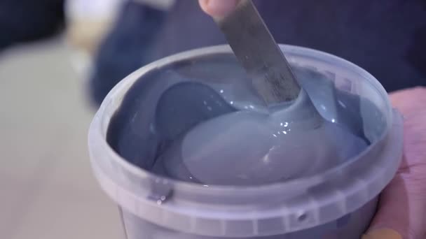 Worker Mixes Gray Paint Bucket Spatula — Stock Video