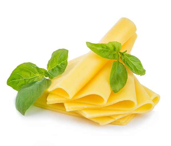 Slices of cheese with fresh basil leaves close-up isolated on a white background.