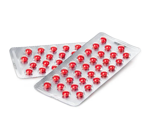 Κόκκινο χάπια σε κυψέλη γκρο πλαν απομονωθεί σε λευκό φόντο. — Φωτογραφία Αρχείου
