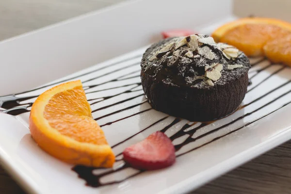 chocolate cake or chocolate lava cake with fresh fruit and coffee