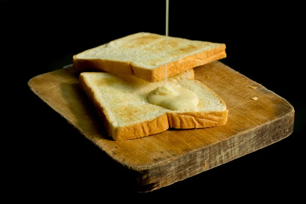 Leite condensado adoçado e pães — Fotografia de Stock