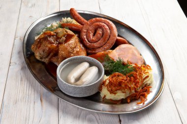 Set of traditional snacks for beer. Sausages, mashed potatoes and cabbage. on a light background