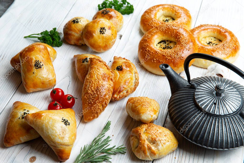 Top view of assorted oriental baked meat pies. samsa. On a light background