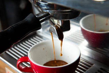 Kahve makinesi fincana kahve doldurur. Yakın plan. Seçici odak