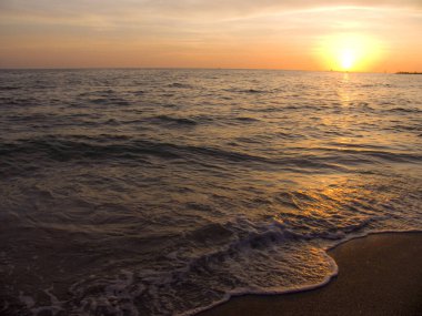 Light sunset rays falling on the waves