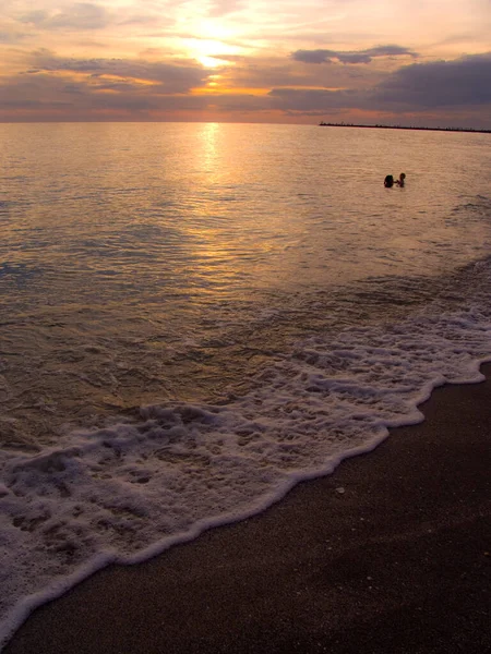 Light sunset rays falling on the waves