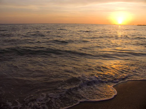 Light sunset rays falling on the waves