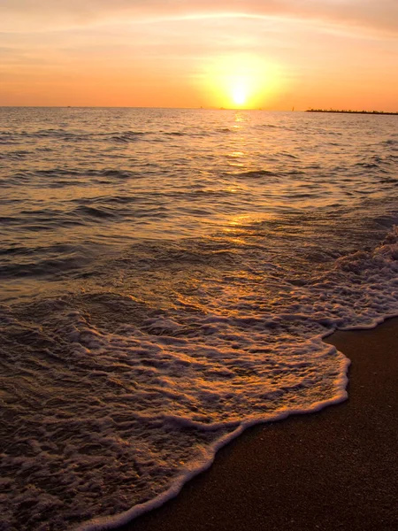 Light sunset rays falling on the waves