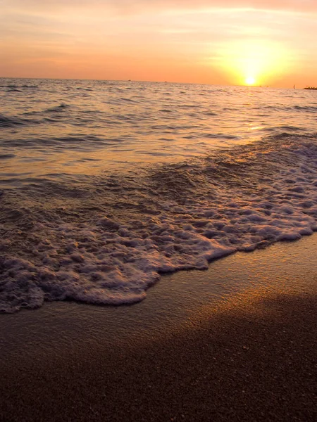 Light sunset rays falling on the waves