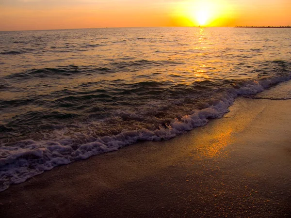 Light sunset rays falling on the waves
