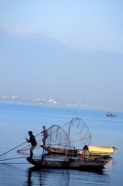 Fisher men fishing in the middle of the sea