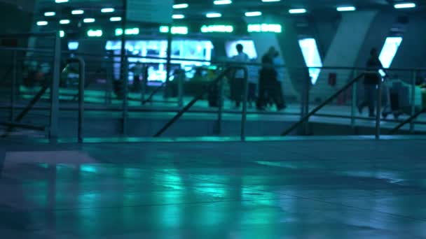 Terreno terminal do aeroporto refletir luzes sopradas de sinais de LED. Carros de táxi. Pessoas a andar com sacos. Chegadas e partidas. Reflexos verdes brilhantes. Dia . — Vídeo de Stock