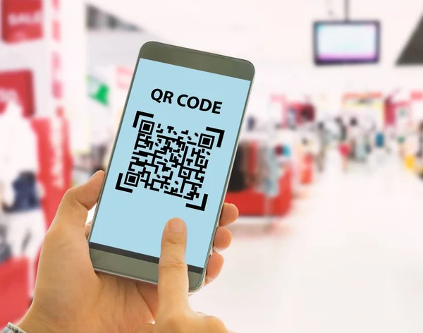 Scan the QR code to a smart phone to pay for goods and services in a superstore for easy and fast. Digital technology concept.