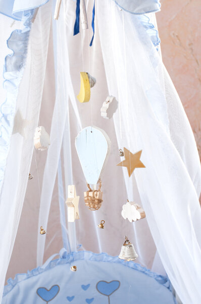 Hanging wooden toys in the crib.