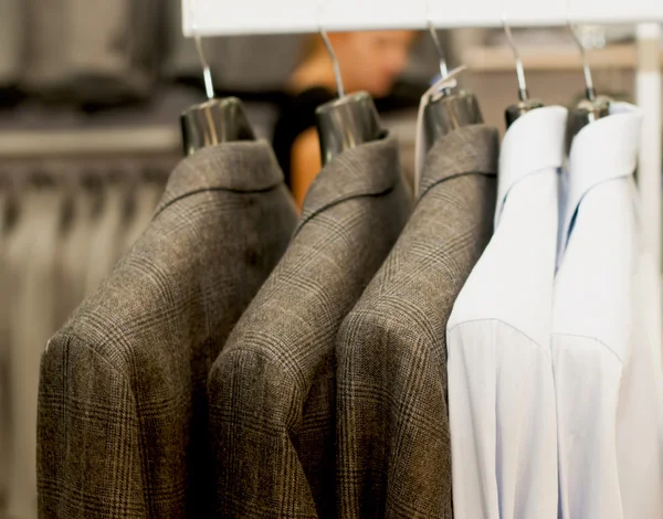 Brown jackets on hangers — Stock Photo, Image