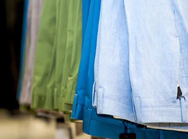 Set of colored pants in the store — Stock Photo, Image