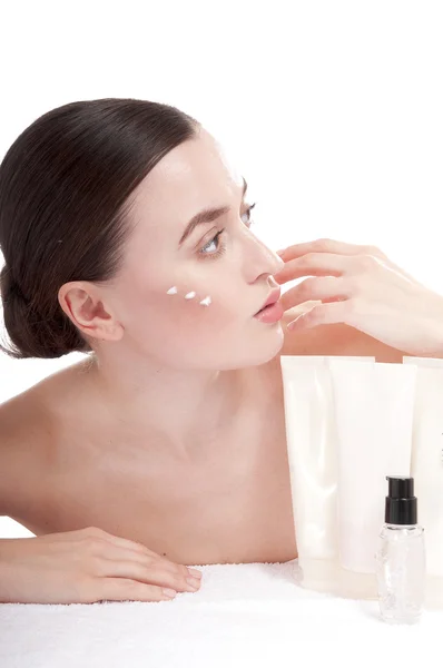 Woman applying cosmetic cream treatment on her face — Stock Photo, Image