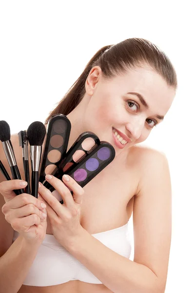 Beautiful smiling woman with set of brushes and palette of color — Stock Photo, Image