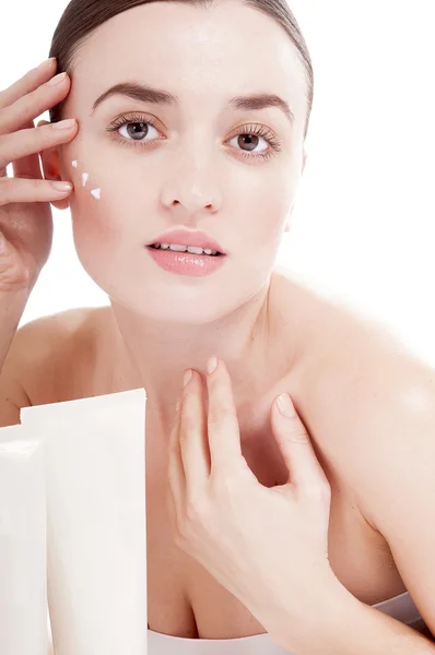 Sensual woman applying cosmetic cream treatment on her face — Stock Photo, Image