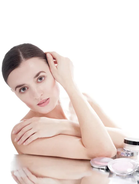 Woman with  a well-groomed skin near the creams cosmetics — Stock Photo, Image