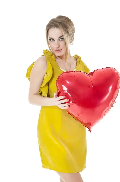 Beautiful woman holding red heart balloon — Stock Photo, Image