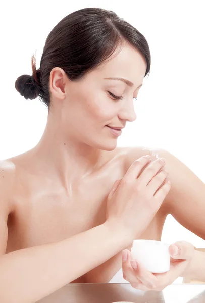 Beautiful woman applying cosmetic cream treatment on her body — Stock Photo, Image