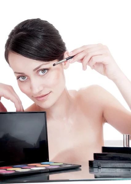 Young beautiful girl applying shadow by brush on the eyelid — Stock Photo, Image