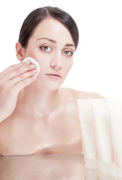 Woman with cotton swab near a tube of cream — Stock Photo, Image