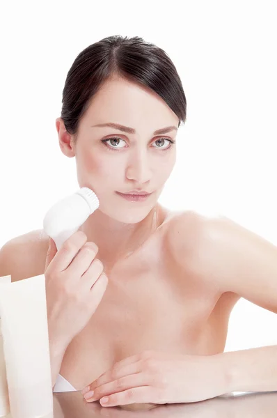 Woman with brush for deep cleansing facial. Skin care concept. — Stock Photo, Image