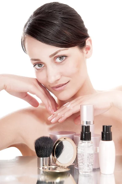 Woman with a good complexion near the creams cosmetics — Stock Photo, Image