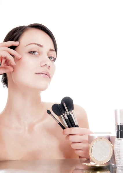 Young woman with makeup brushes near the face — Stock Photo, Image